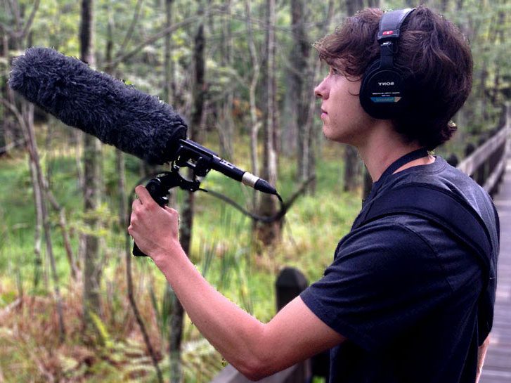 Undergraduate recording, holding microphone